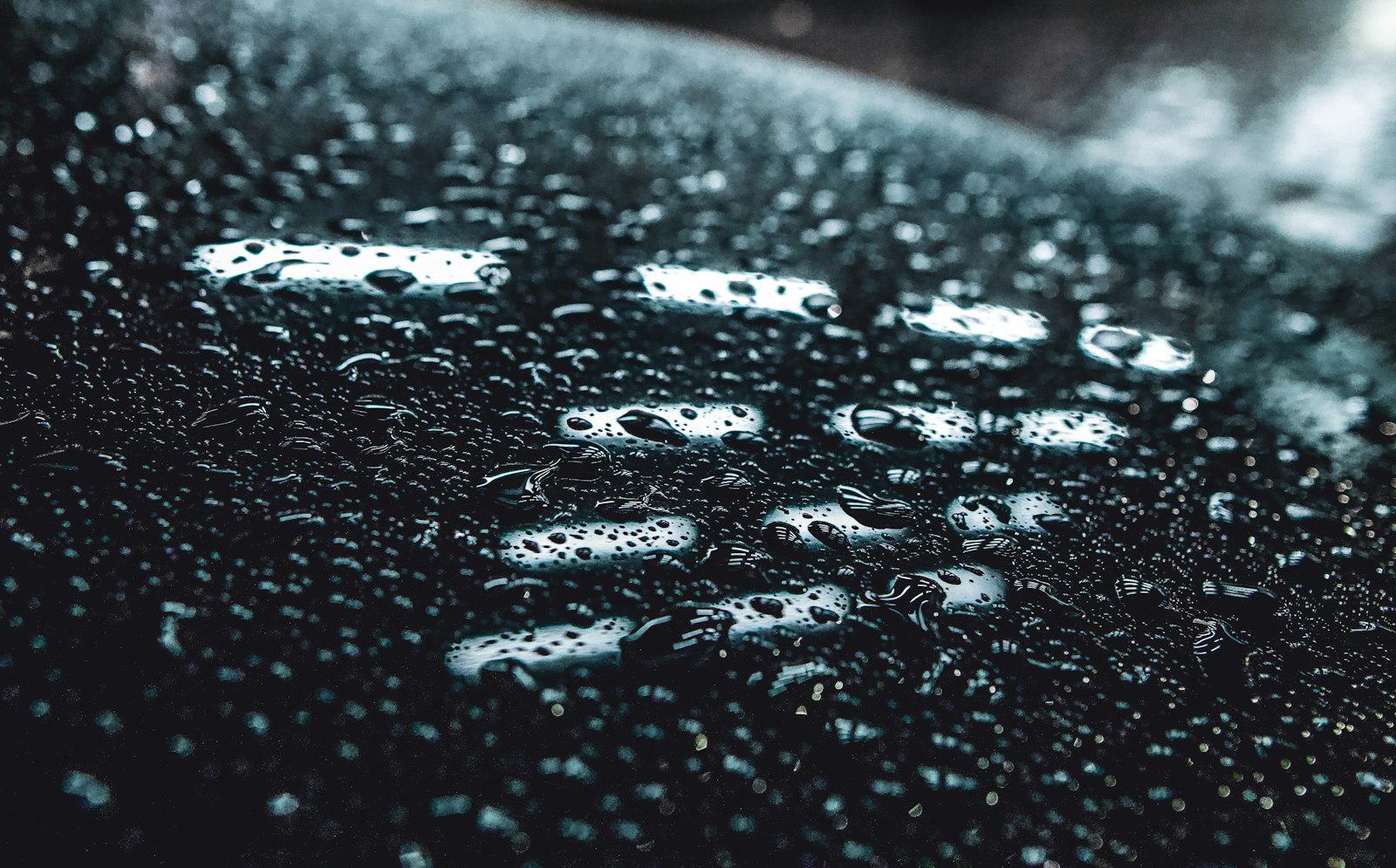 Water beading on a protected black surface